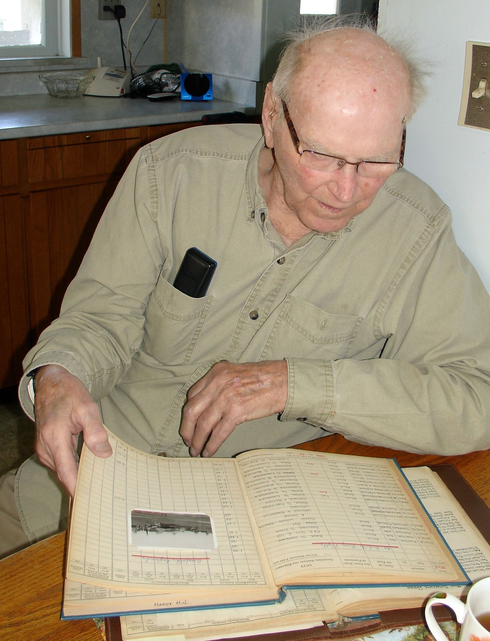 Harry Hardy Looking at his Logbook